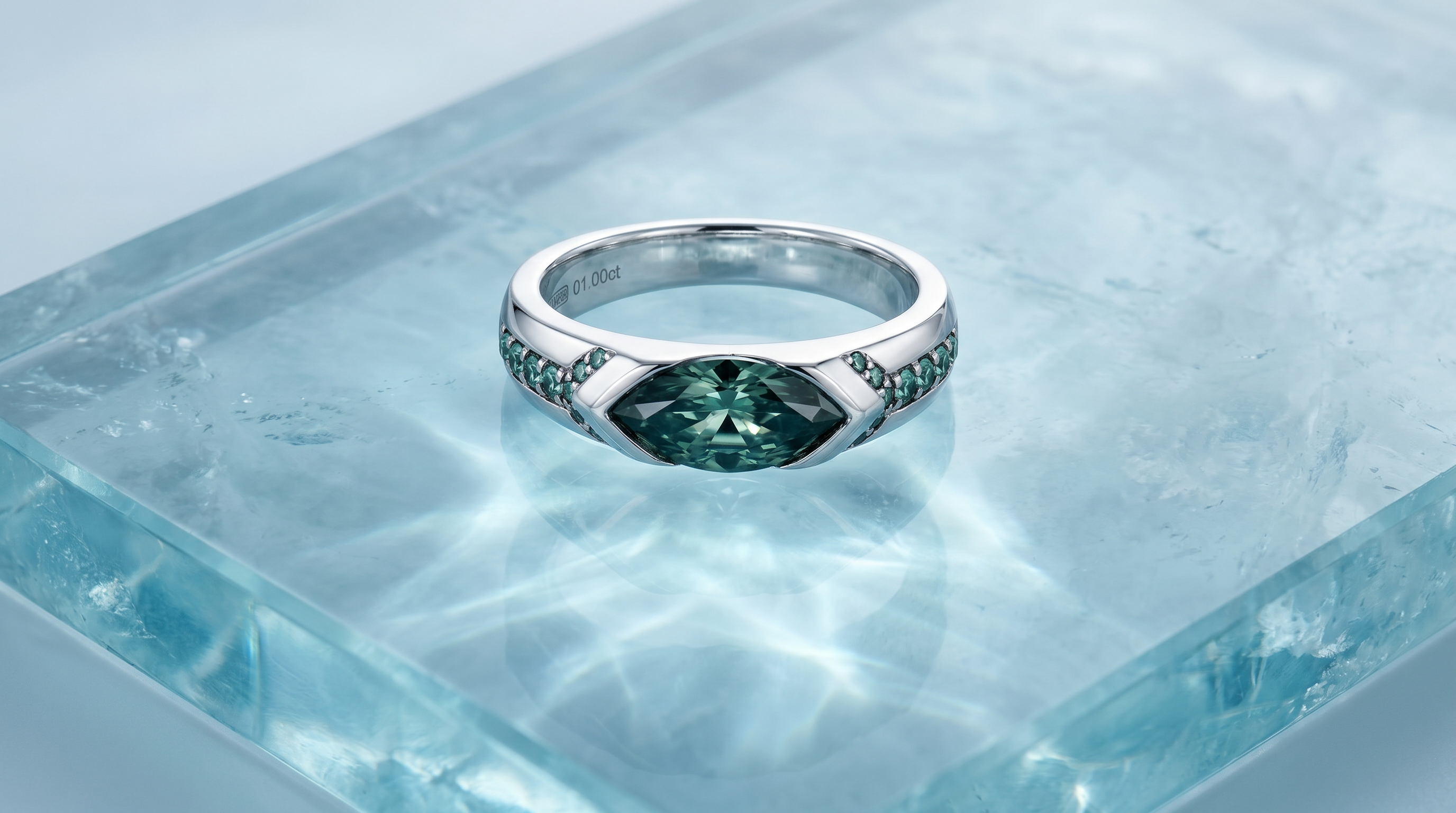 Azure Ice Ring with marquise-cut blue moissanite and pavé-set accent stones in sterling silver displayed on translucent crystal blue stone.